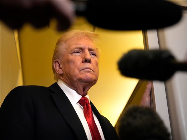 President Donald Trump speaks to reporters aboard Air Force One, Oct. 19, en route to Joint Base Andrews, Md., as he returns from a trip to Florida.
