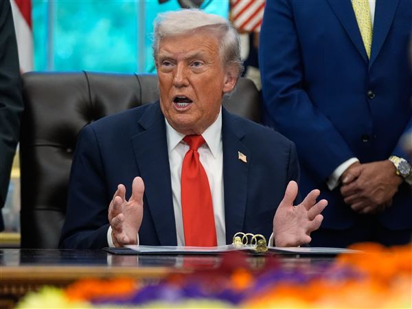 President Donald Trump answers questions from reporters on Oct. 21 in the Oval Office at the White House.