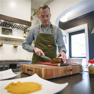 Private chef Jonmorgan Smith prepares an Ahi Tuna Tataki, a dish he would typically make for cruise ship guests, in his home in Toledo on Oct. 17.
