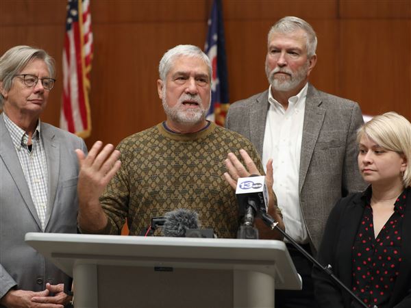 Dr. Johnathon Ross at podium, talks about the Lucas County commissioners’ support for a medical debt forgiveness program during a news conference at One Government Center Tuesday, November 1, 2022, in Toledo.  