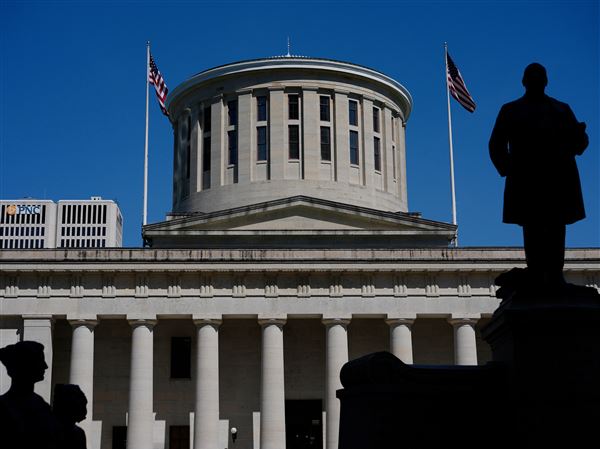 The William McKinley Monument is silhouetted in front of the west side of the Ohio Statehouse on April 15, 2024, in Columbus.