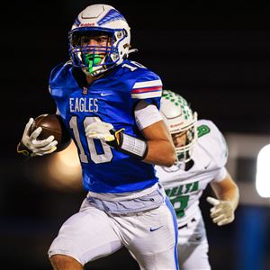 Liberty-Benton's Seth Elchert runs with the ball as the Eagles host Delta in a first round playoff matchup on Oct. 31 in Findlay.