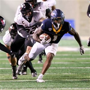 Toledo’s Chip Trayanum runs with the ball against Northern Illinois on Nov. 5 at UT’s Glass Bowl in Toledo.