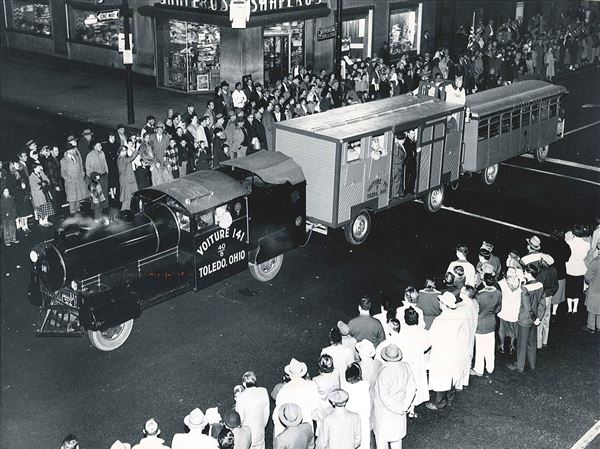 Replica of a French train of World War I days chugs along Jefferson Ave. during a torchlight parade in Toledo on Veterans Day.  Blade photo was published Nov. 12, 1954.