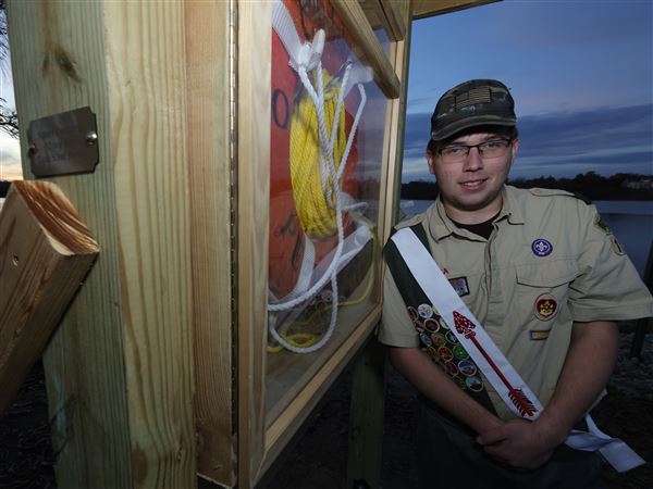 Robert Courtney, 17, set up life ring stations along the Maumee River in a partership with the City of Perrysburg as part of a project to earn his Eagle Scout badge at the Maple Street Boat Launch on Nov. 6 in Perrysburg.