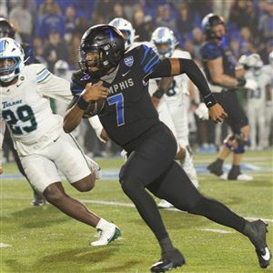 Memphis quarterback Arrington Maiden carries the ball defended by Tulane defensive lineman Santana Hopper during the second half of Friday's game in Memphis.