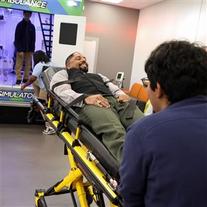 Antonio Lozano, a ninth grader, pushes, Romules Durant, superintendent and CEO of Toledo Public Schools, on a stretcher during a demonstration of the new ambulance simulator at Toledo Pre-Medical and Health Science Academy in Toledo on Nov. 10.
