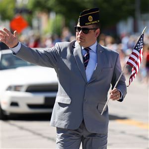State Rep. Haraz Ghanbari waves to the crowd during the Memorial Day parade in Perrysburg on May 26.