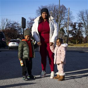 Tanikka Harris, policy council chair of Head Start and Early Head Start programs, stands with her grandchildren Da’merre, 2, and D’ream, 4, Ulis on Nov. 12 in central Toledo. The siblings both benefit from the program.