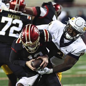 Toledo's Esean Carter pressures Miami quarterback Henry Hesson during  their football game Nov. 12. 
