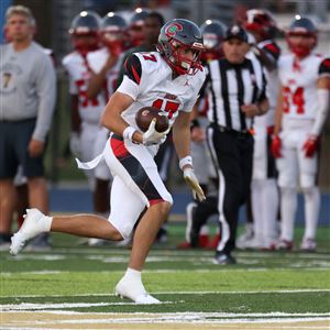 Central Catholic’s Preston Fryzel runs after making a catch during a game against St. John’s Jesuit on Oct. 3 at St. John’s Jesuit High School in Toledo.