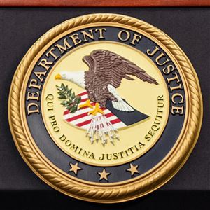 The Department of Justice logo is seen on a podium during a press conference at the U.S. Attorney's Office on Oct. 23.