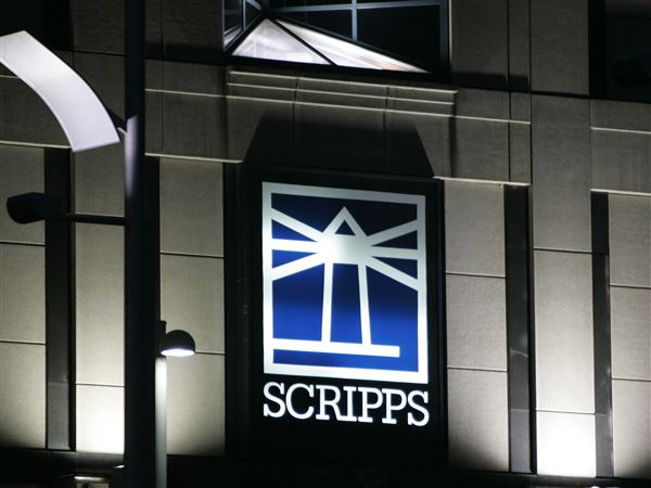 Floodlights light up the E.W. Scripps logo on the company's headquarters in Cincinnati, Jan. 31, 2006.