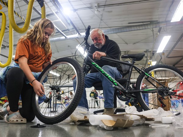 Families build traditions of giving back by building bikes