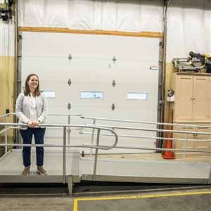 Katie Hunt Thomas, director of advocacy at the Ability Center of Greater Toledo, with an accessibility ramp on Dec. 2 in Sylvania. The city of Toledo, in partnership with the Ability Center, is hosting an in-person focus group to hear from people with disabilities, caregivers, service providers, and community members about the challenges of finding accessible housing in Toledo.