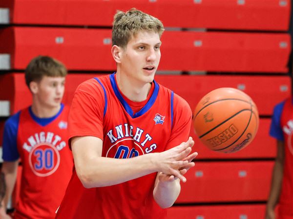 Alan Horton passes the ball during basketball practice at St. Francis de Sales in Toledo on Dec. 1.