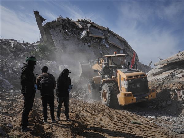 Islamic Jihad and Hamas militants search for the remains of deceased hostages on Dec. 3 in Beit Lahiya, northern Gaza Strip.