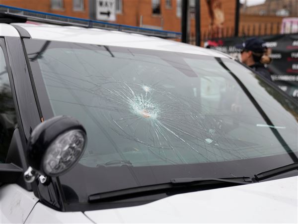 The wind shield of a Chicago police vehicle is smashed as people protesting the actions of federal immigration agents in Little Village clash with Chicago police officers on Nov. 8 in Chicago.