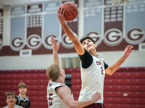 Walter Plantz leaps for a rebound during Genoa's boys basketball practice at their home gym on Dec. 2 in Genoa, Ohio.