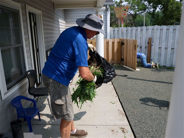 Rotary members roll up their sleeves to serve across the city